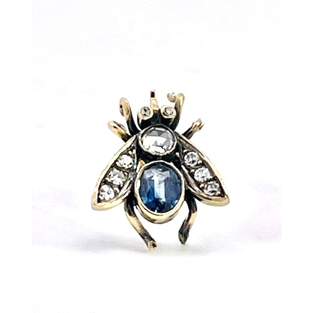 This is a striking pair of antique-style bee (or fly) earrings, crafted in gold with oxidized silver detailing that gives...