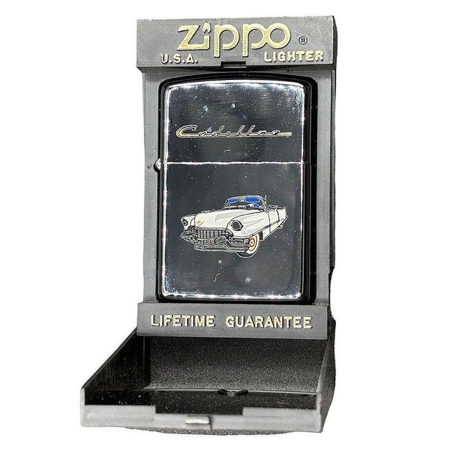 Used Zippo Lighter featuring a highly polished case with a 1955 Cadillac Emblem Design on the front and back with Display...