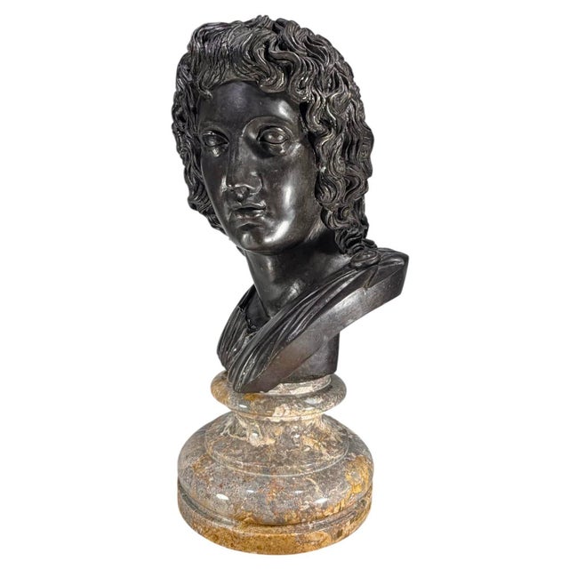 Large Neoclassical Style Bronze Bust depicting Apollo, mounted on a polished marble pedestal base. Apollo was the Greek...