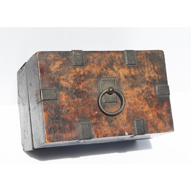 Continental burlwood box. 18th century or earlier. Original iron straps. Remnants of a silk lining.