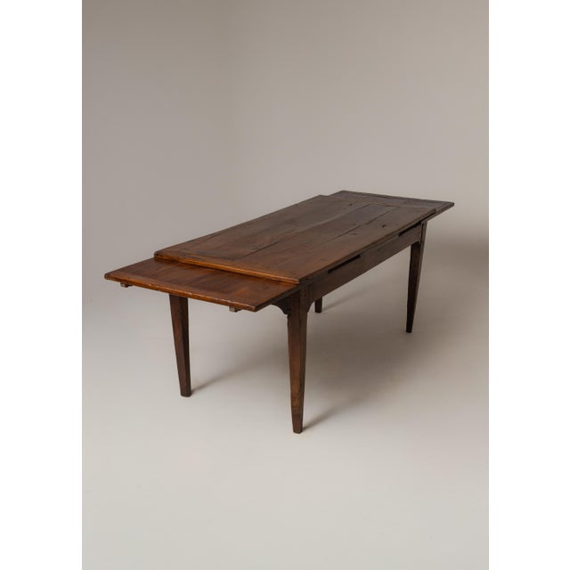 A French Provincial farmhouse dining table, circa late 18th/early 19th century, in solid cherry or fruitwood. The planked...