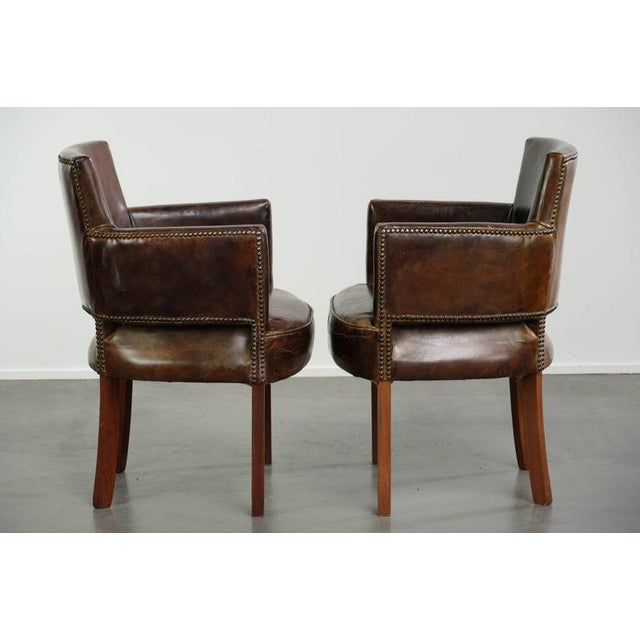 This set of 2 vintage dining chairs is made of grained cowhide leather with deep colors and a comfortable seat. The chairs...