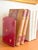 Fantastic pair of red leather and gilt folding bookends with brass hinges. Fleur de Lis and Lion markings indicate...