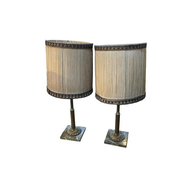 Pair of vintage Empire style metal lampshades on a marble base Elegant pair of 20th-century Empire style metal lampshades...