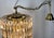 Large cascading Murano glass chandelier from the 1980s. Composed of a gilded brass frame from which hang 70 triangular...