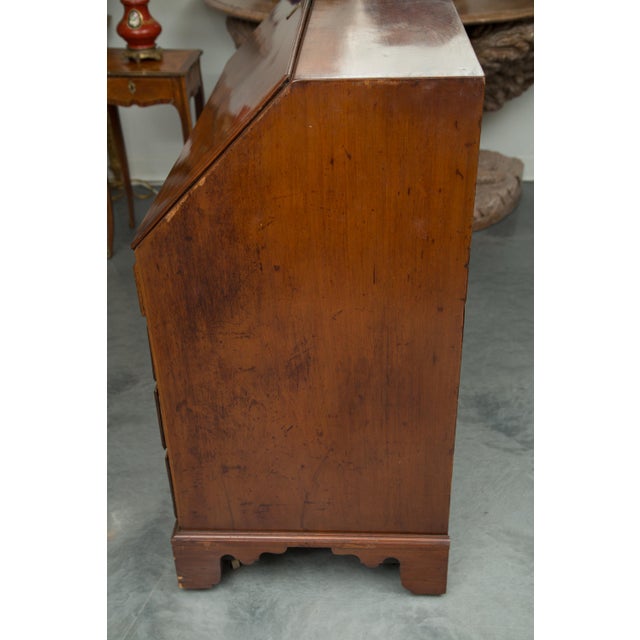This is a Classic George III mahogany slant top desk. The slant front drops to reveal a series of small drawers and...