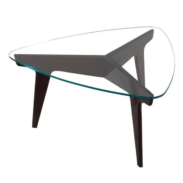 Coffee table is an item of original design furniture realized by Gio Ponti in the 1950s. Mahogany wood and crystal top....