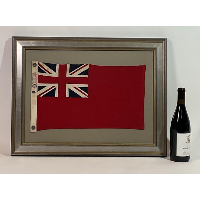 Framed English navy red ensign flag. Red field with Union Jack in the top left corner. Canvas bunting with label from...