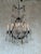 This large, French 1920s six-light chandelier features cut glass and crystal components, refracting the light beautifully....