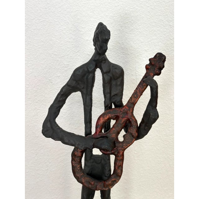 Up for sale is this evocative sculpture of a guitarist - but is he playing rock or jazz... or other? That's up to you to...