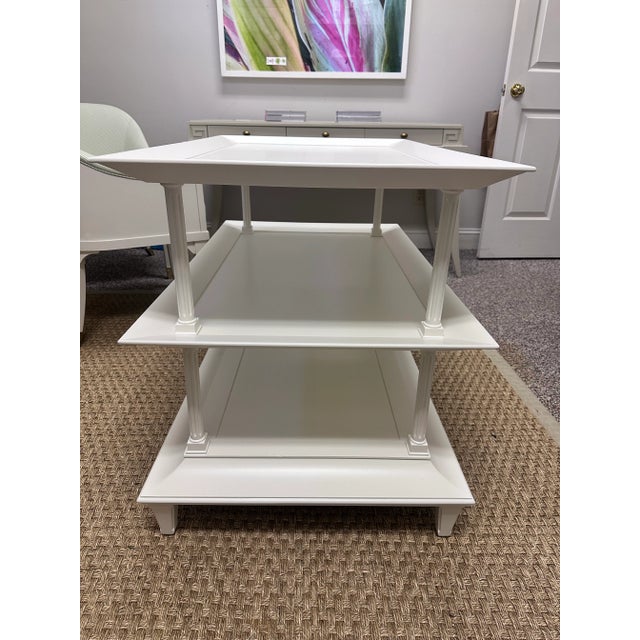 Elegant and timeless three tier table from Baker Furniture. Featuring clean lines, flared tray style shelves, and classic...
