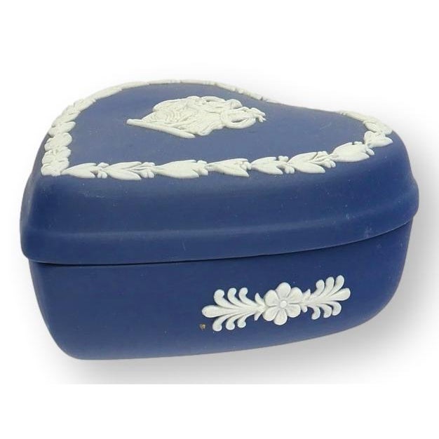Classic Wedgwood Jasperware heart-shaped trinket box in cobalt blue with cream neoclassical relief decoration. A charming...