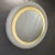 Round backlit mirror in white lacquered wood. Period: 1970s Material: White lacquered wood with neon backlighting...