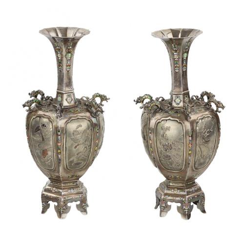A pair of fine Japanese vases in silver, decorated with minute applications of polychrome enamel with floral motifs. The...