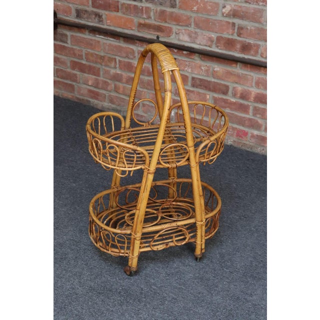 Mid-Century Modern bar cart / trolley / rolling server in woven bamboo, wicker and rattan (ca. 1960s, Italy). Features two...