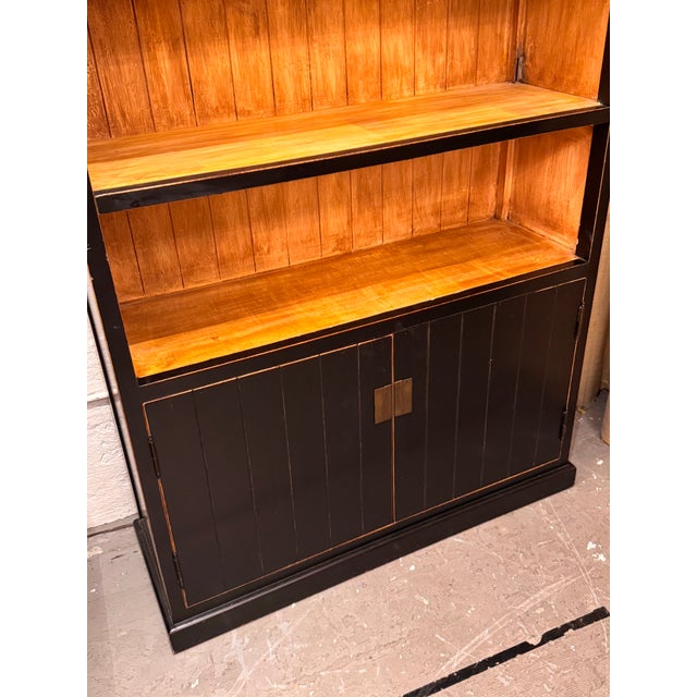 Design Plus Gallery presents a Traditional Asian Wood Storage Bookcase with a black painted exterior and contrasting...