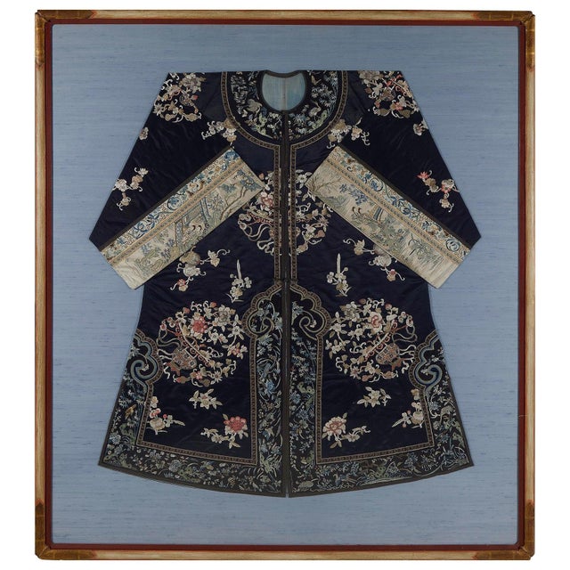 A woman's coat made of black silk with wide sleeves from Chinese late Qing Dynasty (mid to late 19th century), mounted and...