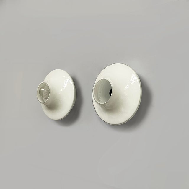Italian modern round wall lamps in opaline glass, 1970s Pair of wall lamps with round opaline glass diffuser. The light...