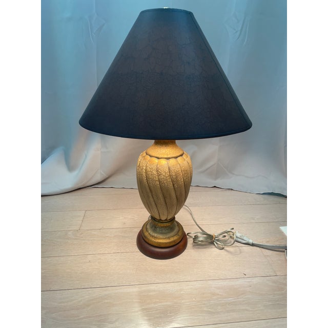 Bring striking contrast and rich texture to your space with this vintage ceramic table lamp. The bulbous body features a...