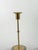 Elegant pair of Scandinavian Modern candlesticks featuring polished brass stems mounted on substantial frosted glass...