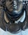 Grecian face door knocker, made of cast iron and painted black.