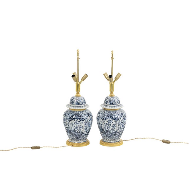 Pair of Delft earthenware lamps. Frame in gilded and chiseled bronze. French work realized circa 1880. This piece is...