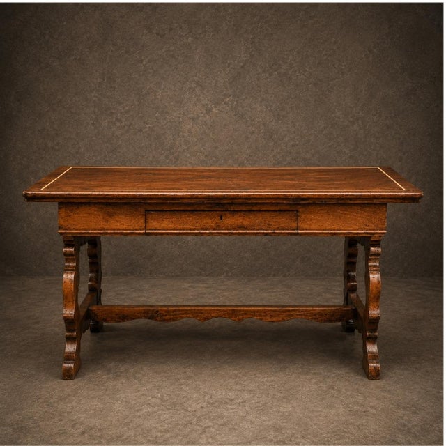 The 18th Century Italian Walnut Writing Table is a timeless example of Old World craftsmanship and refined European...