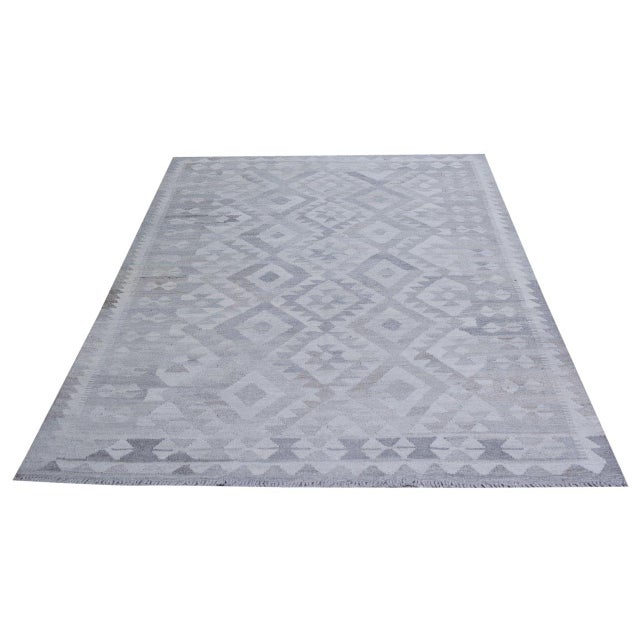 Hand-knotted with care using traditional rug-making techniques, this wool rug blends timeless craftsmanship with a modern...