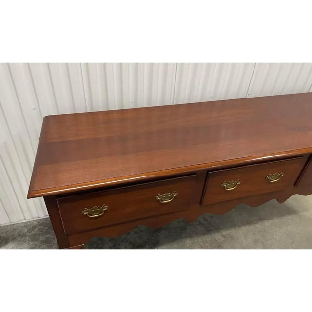 Offered is a lovely vintage Queen Anne style sideboard by The Bartley Collection. This piece features three dovetailed,...