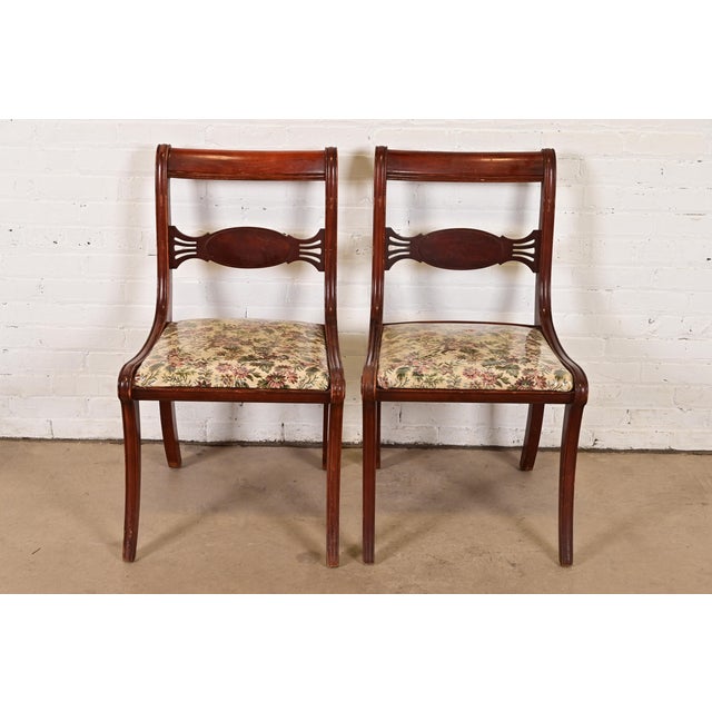 A gorgeous pair of Regency style side chairs or dining chairs In the manner of Kindel Furniture USA, Circa 1940s Carved...