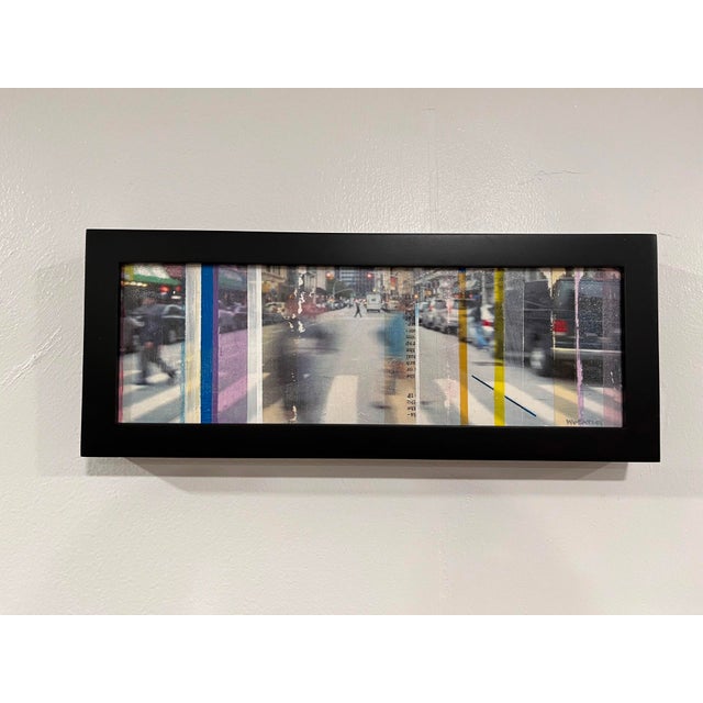 This mixed-media piece combines photography, collage, and acrylic on a panel, creating a dynamic urban scene that captures...