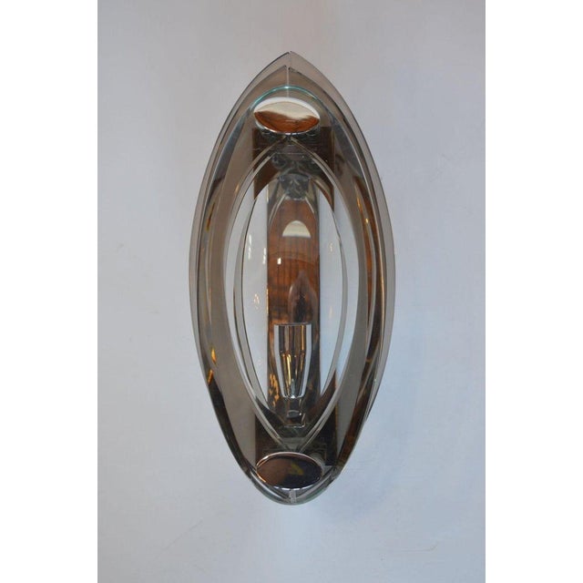 A refined and sculptural pair of Italian Mid-Century wall sconces designed by Fontana Arte, dating to the 1960's and...
