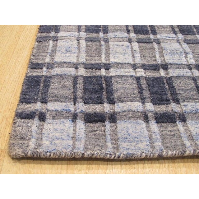 This gray bamboo silk rug features a hand knotted pile weave and falls under the EORC Rugs style category. Manufactured in...