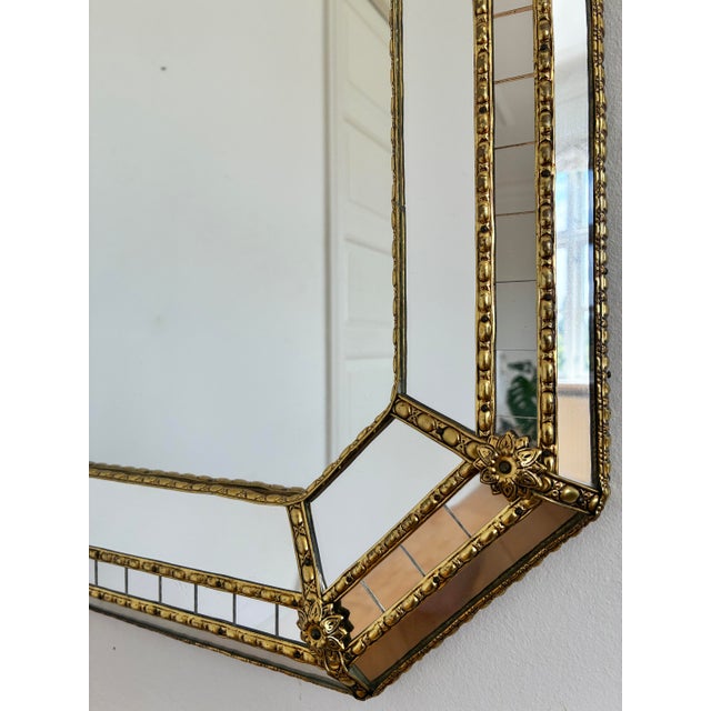 A large vintage Spanish Venetian-style Octagonal beveled wall mirror, dating to the 1980s. The mirror has a decorative...