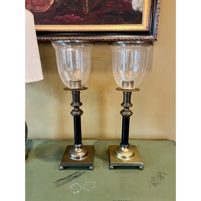 Pair Of Regency Style Brass Hurricane Lamps - Gorgeous neoclassical candlestick hurricanes featuring black columns on...