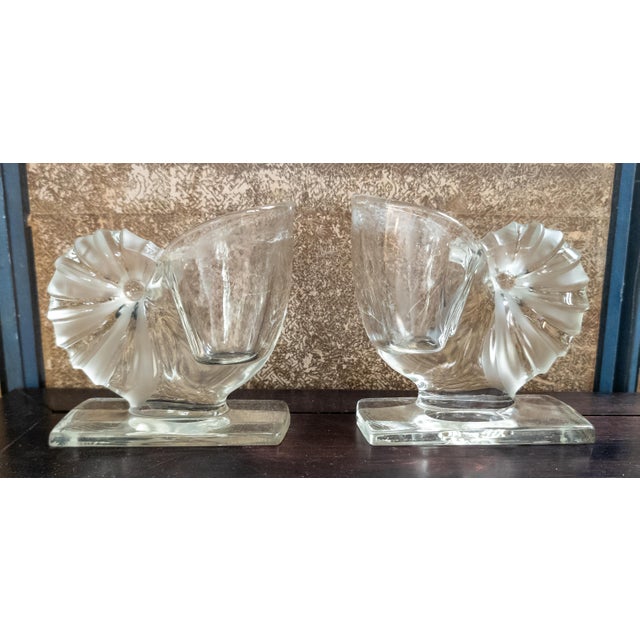 We are selling this decorative pair of 20th century clear glass Nautilus shell flower holders or bookends. These pieces...