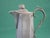 This 18th-19th century American pewter syrup jug with lid creamer is a rare and handmade piece from the United States. The...