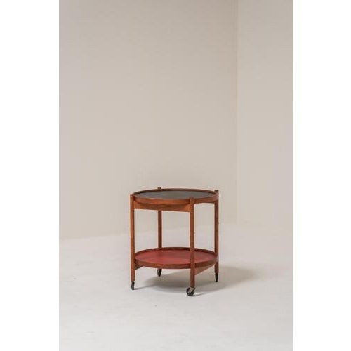 Elegant vintage serving trolley designed by Hans Bølling in Denmark during the 1960s. This refined Scandinavian design is...
