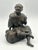 Finely modeled Japanese Meiji-period patinated bronze okimono, circa 1890–1910, depicting a seated man enjoying a...