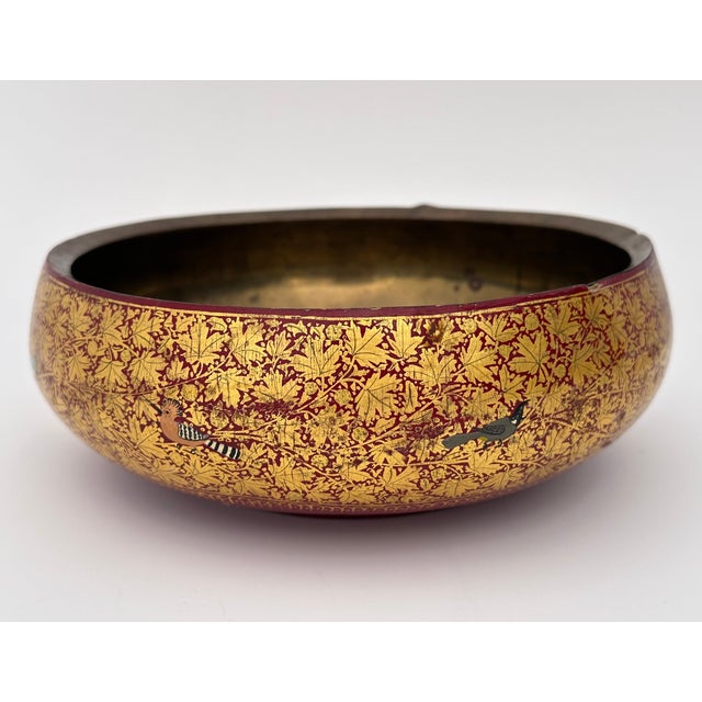 A decorative hand-painted Kashmiri paper mache bowl with brass lining. Its surface is covered with golden maple leaves and...