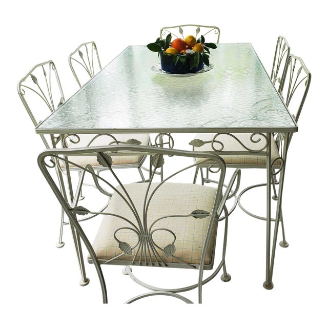 Wrought Iron Leaf Pattern Table and 6 chairs attributed to Salterini. Was purchased in 1968. Glass Top is original, and...