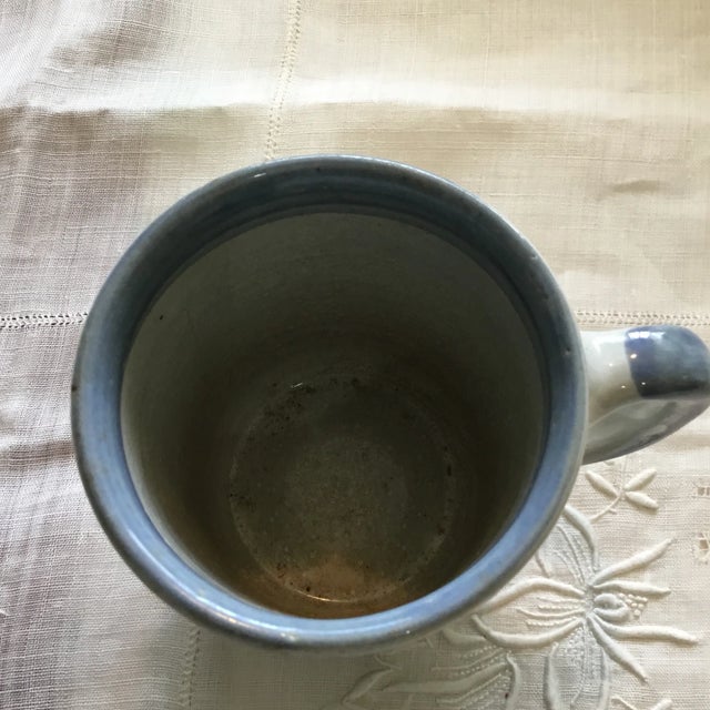 Pottery. Hand made it. Light gray, blue, orange, green and yellow colors on it. Louisville Stoneware.