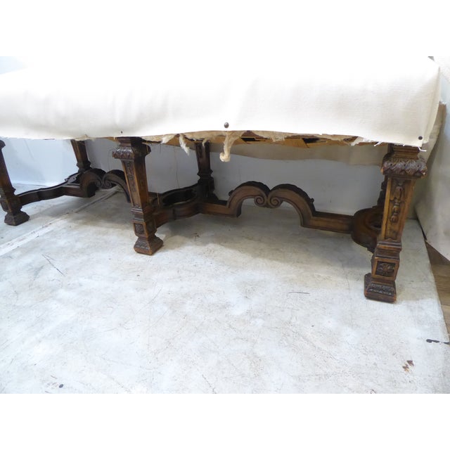 This 19th Century carved walnut bench needs to be upholstered, has springs, measures 19"H x 52"L x 17"D.