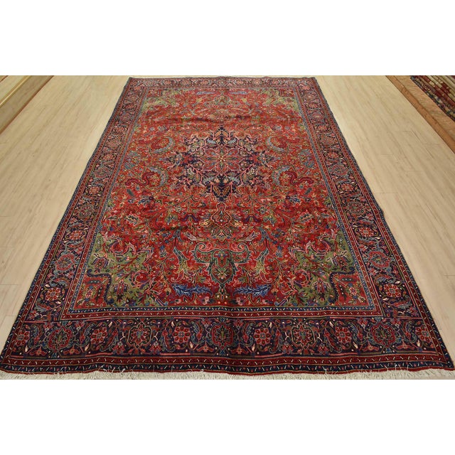 An authentic vintage traditional Heriz rug hand-knotted with fine wool and natural dyes. This rug features a central...