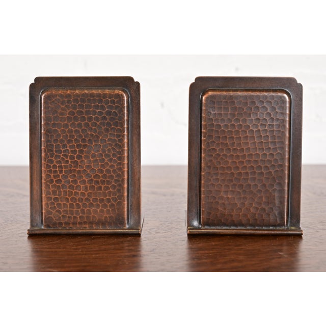 A gorgeous pair of Arts & Crafts period hand hammered copper bookends By Roycroft (signed with impressed orb and cross...