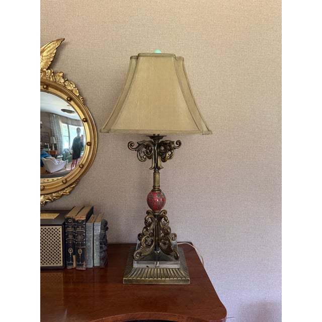 This listing is for a heavy, large table lamp. It features a coral red, hand-painted porcelain detail with brass...