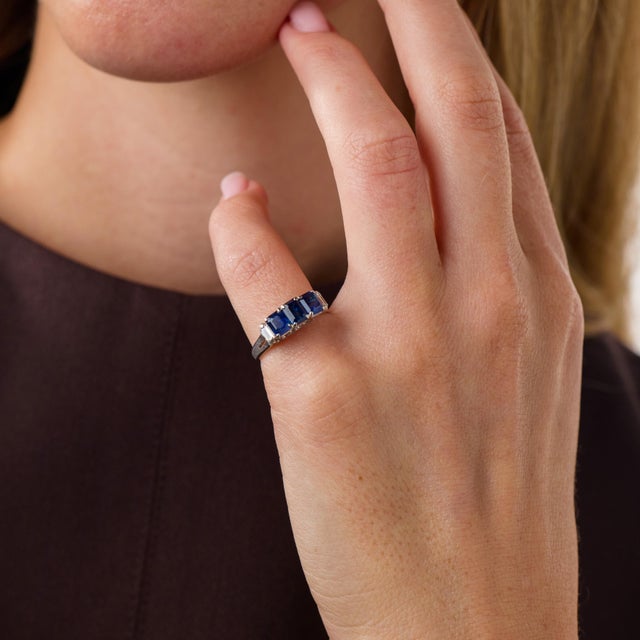 This elegant vintage sapphire and diamond ring is a beautifully balanced design from the 1990’s, featuring 3 emerald cut...