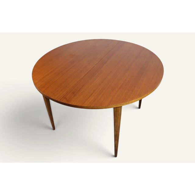 An elegant round teak dining table dating from the 1960s, with clean, warm lines typical of Scandinavian design from that...
