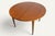 An elegant round teak dining table dating from the 1960s, with clean, warm lines typical of Scandinavian design from that...