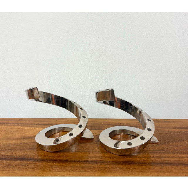 A sculptural pair of vintage candle holders crafted in polished chrome with dramatic sweeping spiral forms. Each features...